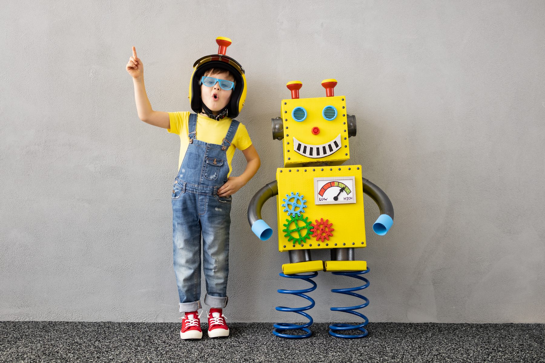 A student with a robot built for a class project.